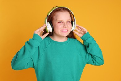 Cute indie girl in headphones on yellow background