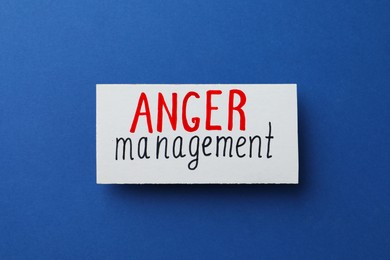 Card with words Anger Management on blue background, top view