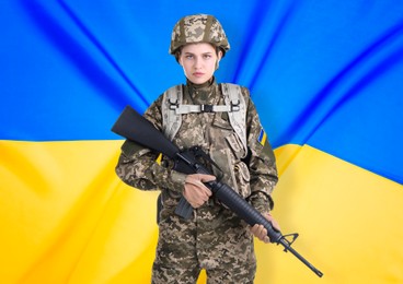 Armed soldier in military camouflage uniform and Ukrainian flag on background. Stop war