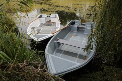 Modern boats with wooden oars on lake