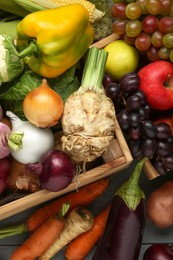 Photo of Different fresh vegetables and fruits with crate on grey wooden table, top view. Farmer harvesting