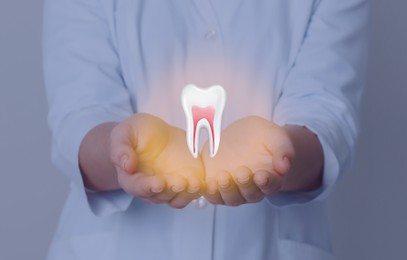 Dentist showing virtual model of tooth on grey background, closeup