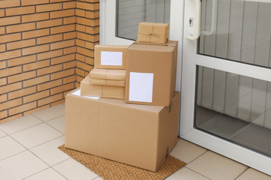 Delivered parcels on door mat near entrance