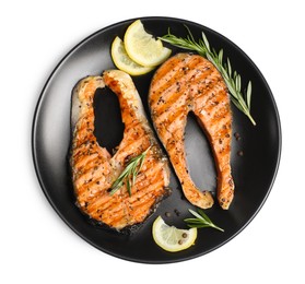 Plate with tasty salmon steaks, rosemary and lemon on white background, top view