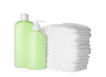 Photo of Stack of disposable diapers and toiletries on white background