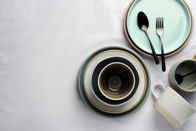 Stylish empty dishware and cutlery on table, flat lay. Space for text