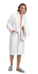Young man in bathrobe with towel on white background