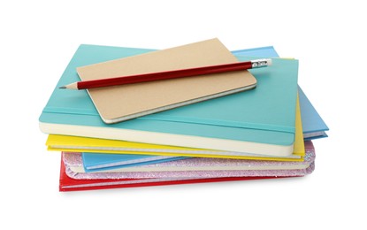 Stack of different colorful hardcover planners and pencil on white background