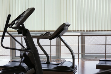 Elliptical trainer and treadmill in gym. Modern sport equipment
