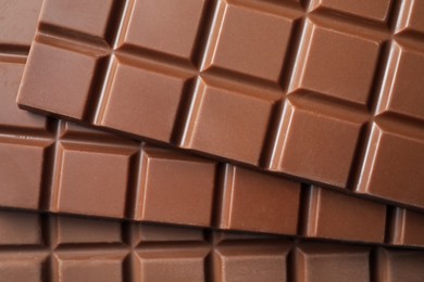 Photo of Delicious milk chocolate bars as background, top view