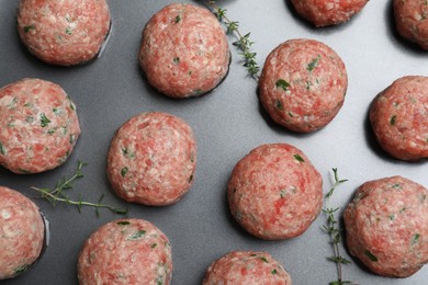 Many fresh raw meatballs on baking dish, flat lay