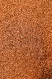 Aromatic cinnamon powder as background, top view