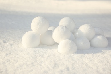 Pile of perfect round snowballs on snow outdoors
