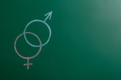 Gender symbols drawn on green chalkboard, space for text. Sex education