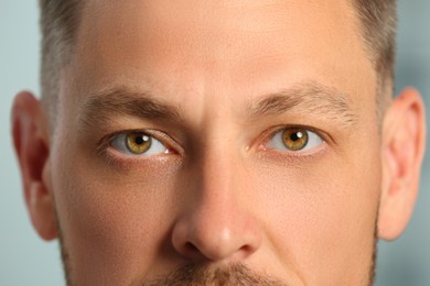Closeup view of man with beautiful eyes on blurred background