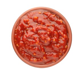 Photo of Delicious adjika sauce in bowl isolated on white, top view