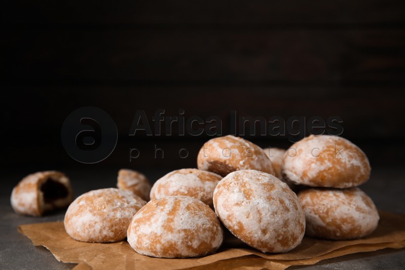 Photo of Tasty homemade gingerbread cookies on grey table, space for text