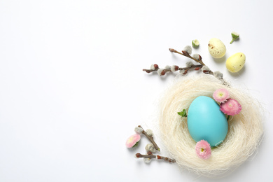 Flat lay composition with Easter eggs on white background. Space for text