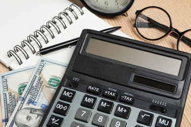 Calculator, money and stationery on table, closeup. Tax accounting