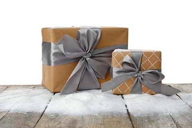 Christmas gift boxes and snow on table against white background