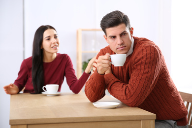 Photo of Couple having quarrel in cafe. Relationship problems