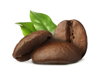 Aromatic roasted coffee beans and fresh green leaves on white background