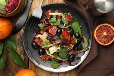 Delicious salad with sicilian orange served on wooden table, flat lay