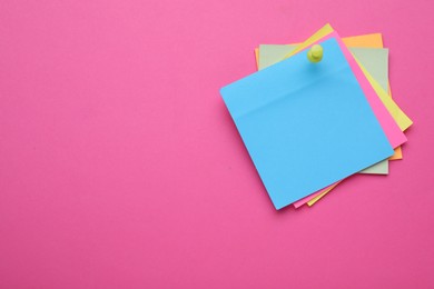 Colorful empty notes pinned on pink background, space for text