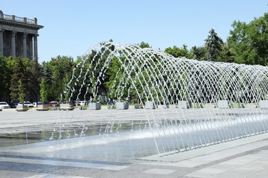 City square with beautiful fountains on sunny day
