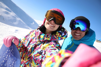 Couple taking selfie on hill. Winter vacation