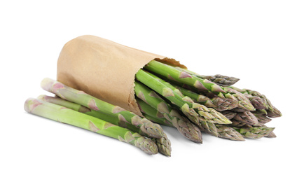 Fresh raw asparagus in paper bag isolated on white. Healthy eating