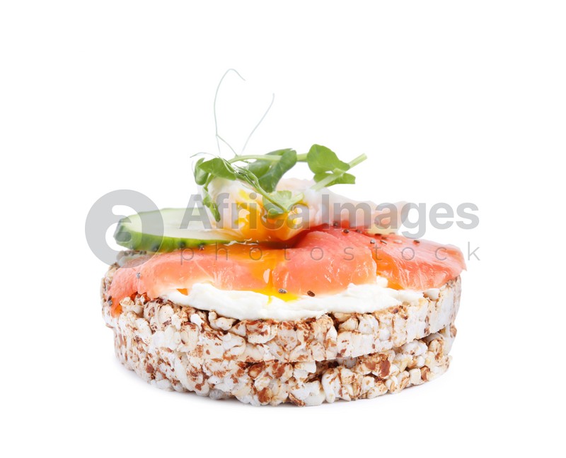 Crunchy buckwheat cakes with salmon, poached egg and cucumber slices isolated on white