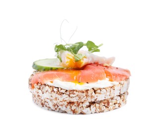 Crunchy buckwheat cakes with salmon, poached egg and cucumber slices isolated on white