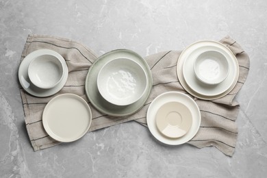 Set of clean tableware on grey table, flat lay