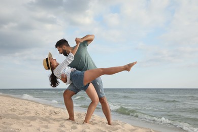 Lovely couple dancing on beach. Time together
