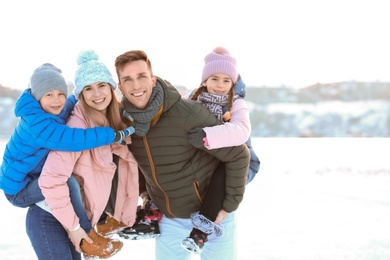 Portrait of happy family outdoors on winter day