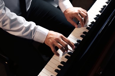Man playing piano, above view. Talented musician