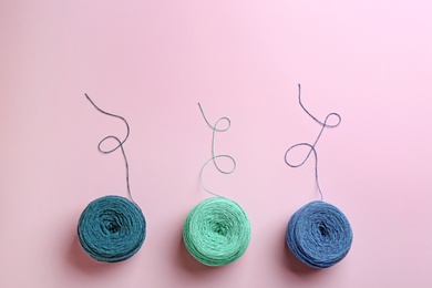 Clews of knitting threads on color background, flat lay with space for text. Sewing stuff