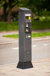 Parking meter on city street, Modern device