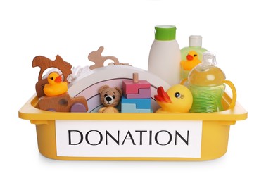 Donation box full of different toys and baby accessories isolated on white