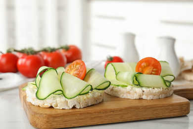 Puffed rice cakes with vegetables on white table