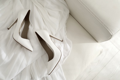 White wedding shoes on sofa, above view
