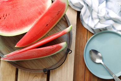 Sliced fresh juicy watermelon on wooden table, flat lay