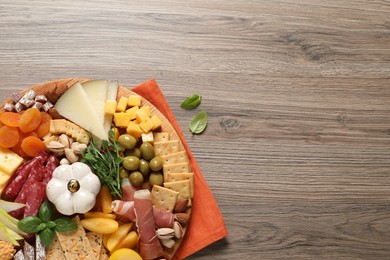 Different tasty appetizers on wooden table, flat lay. Space for text