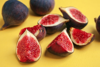 Delicious ripe figs on yellow background, closeup