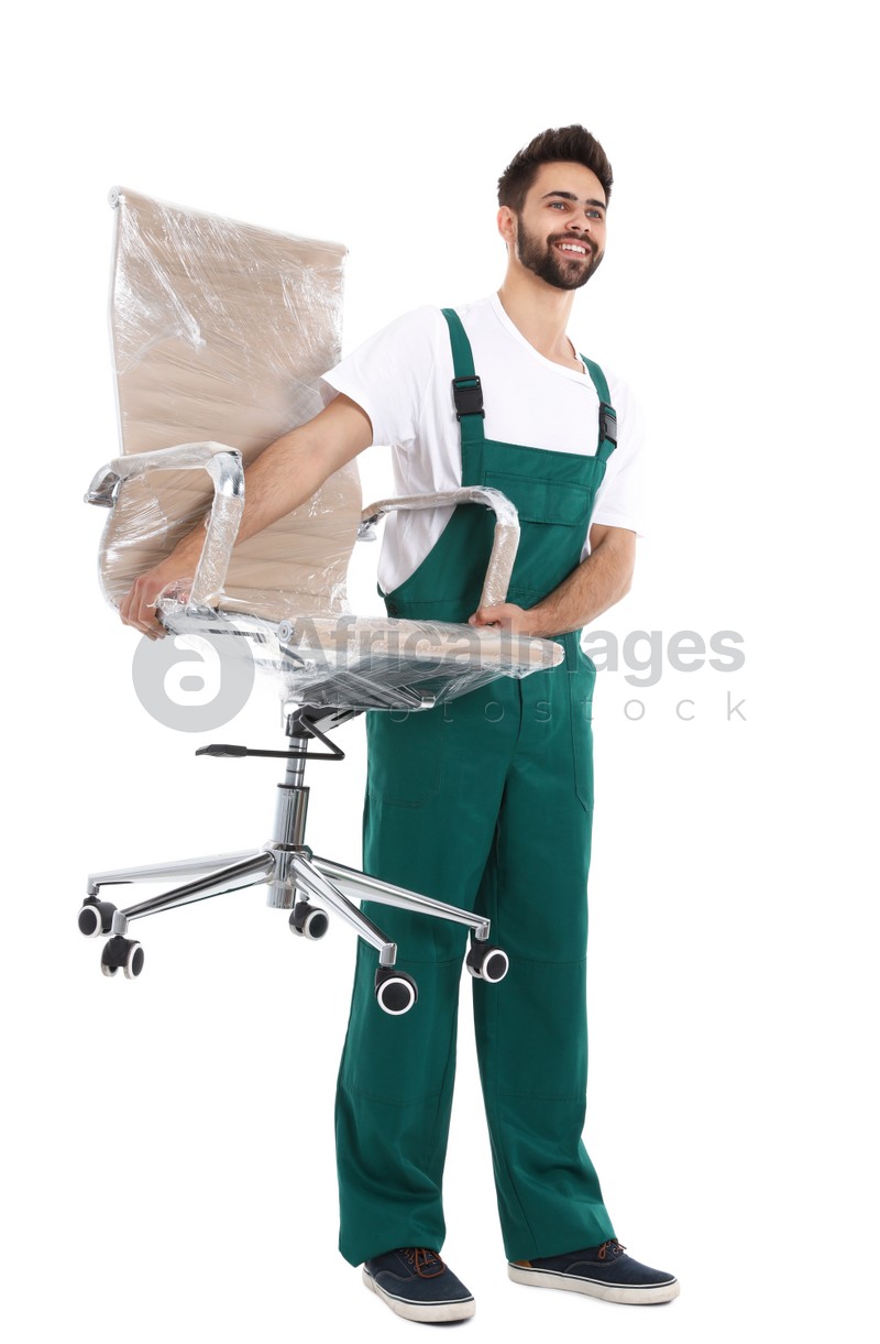 Young worker carrying office chair isolated on white. Moving service