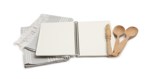 Blank recipe book, napkin and wooden utensils on white background. Space for text