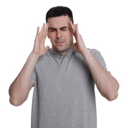 Young man suffering from headache on white background. Cold symptoms