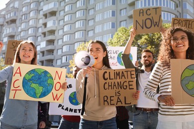 Group of people with posters protesting against climate change outdoors