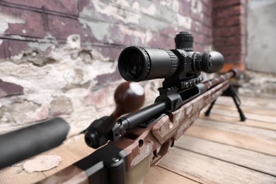 Closeup view of modern powerful sniper rifle with telescopic sight outdoors